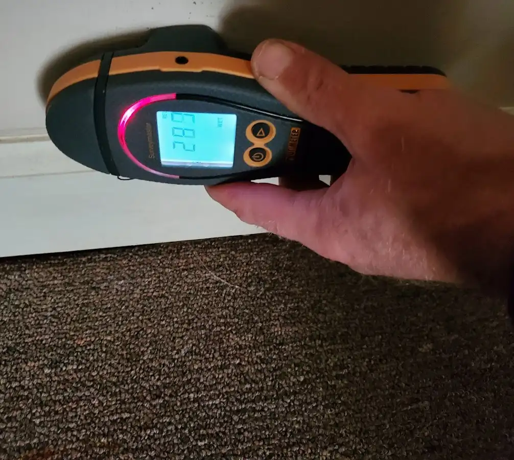 Moisture detection at baseboard during Storm Damage Restoration in Atlanta